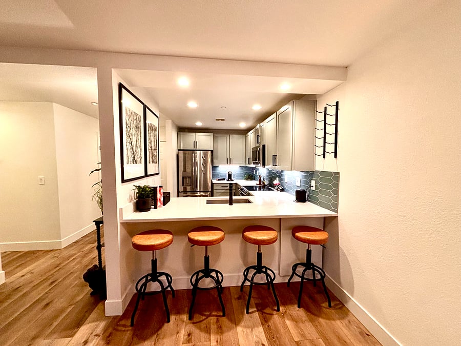 Bright, energy-efficient lighting highlights the subtle textures and tones of the kitchen's finishes, while the open layout invites creativity and connection.