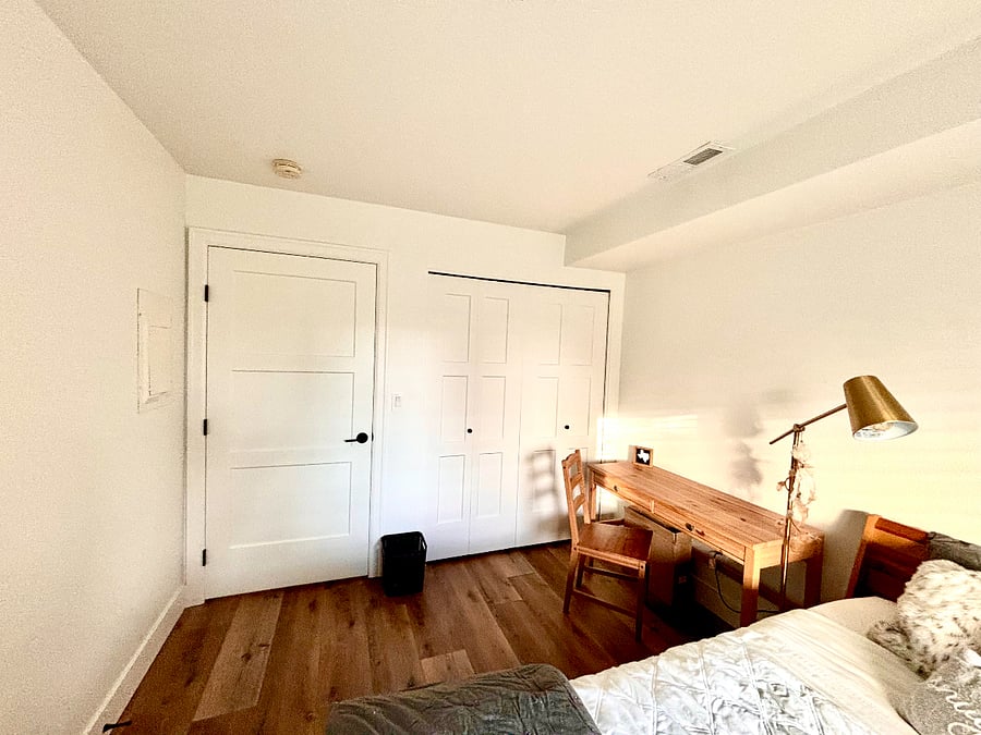 The rooms calming ambiance is enhanced by thoughtful touches, including a spacious wall closet equipped with a smart organization system, ensuring everything has its place. This cozy retreat blends style and functionality, creating the perfect sanctuary for relaxation and peaceful living.