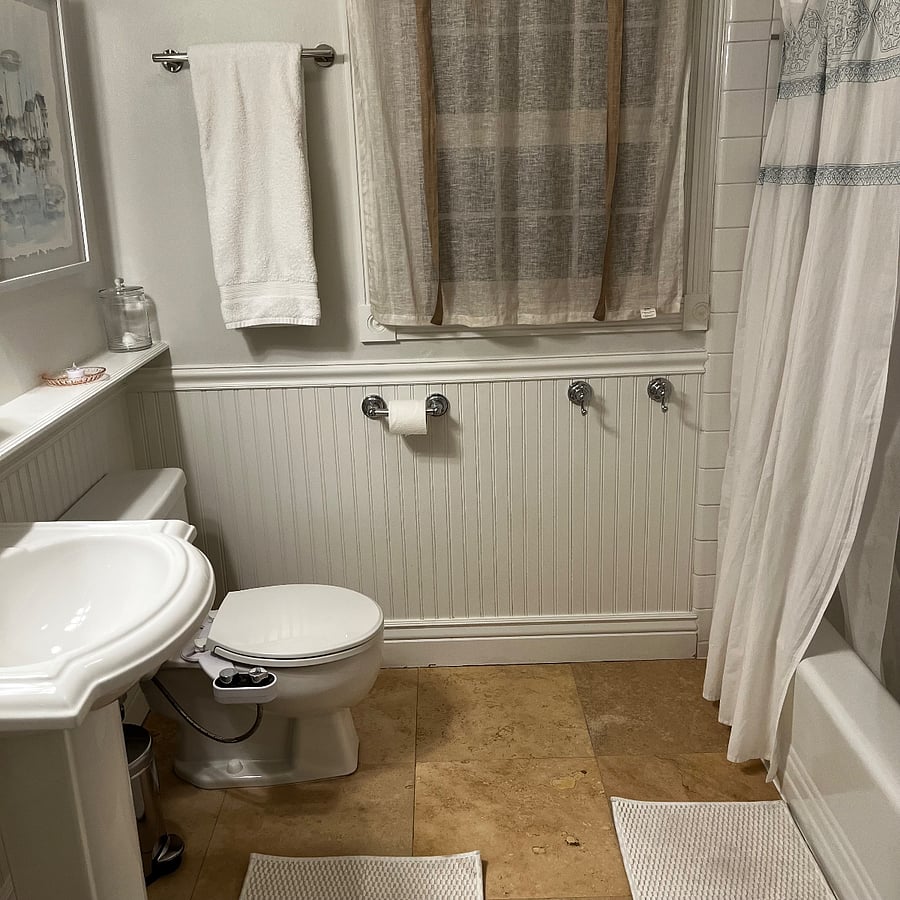 Bunk room bathroom with tub & shower. This bathroom also serves as a guest bathroom.