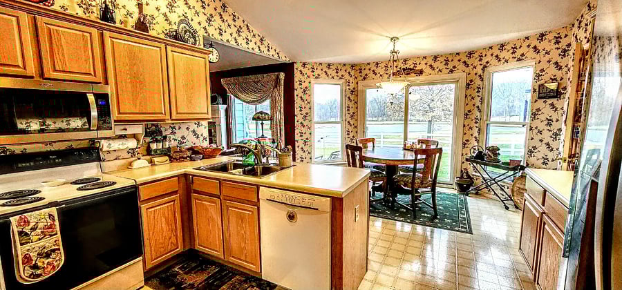 View of kitchen from hallway entrance of laundry room.