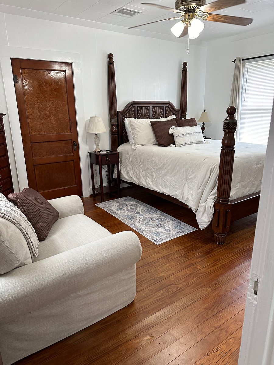 Bedroom with Queen size bed new comfortable mattress. Oversized reading chair and small dresser