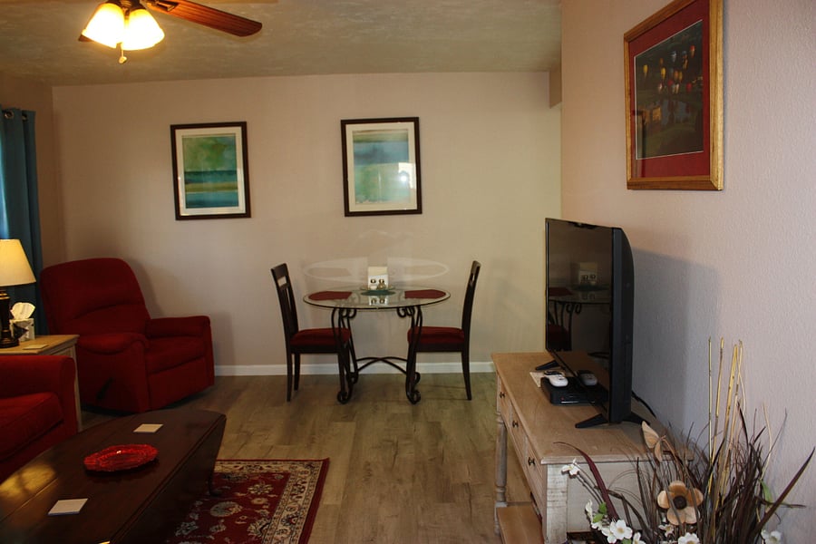 Living room with kitchen table near kitchen area