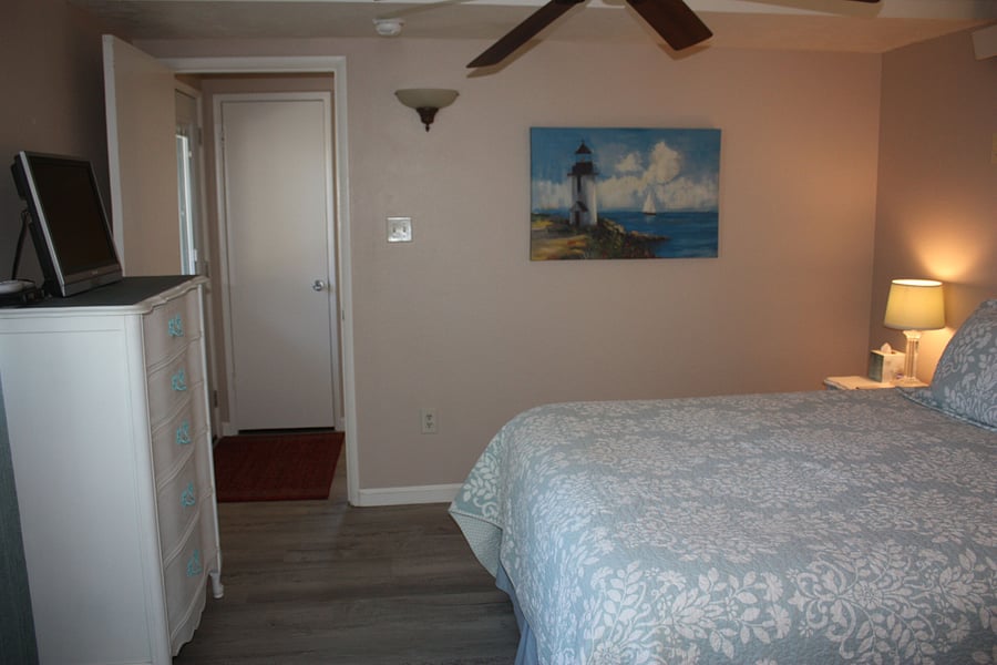 Bedroom facing main entry and coat closet door