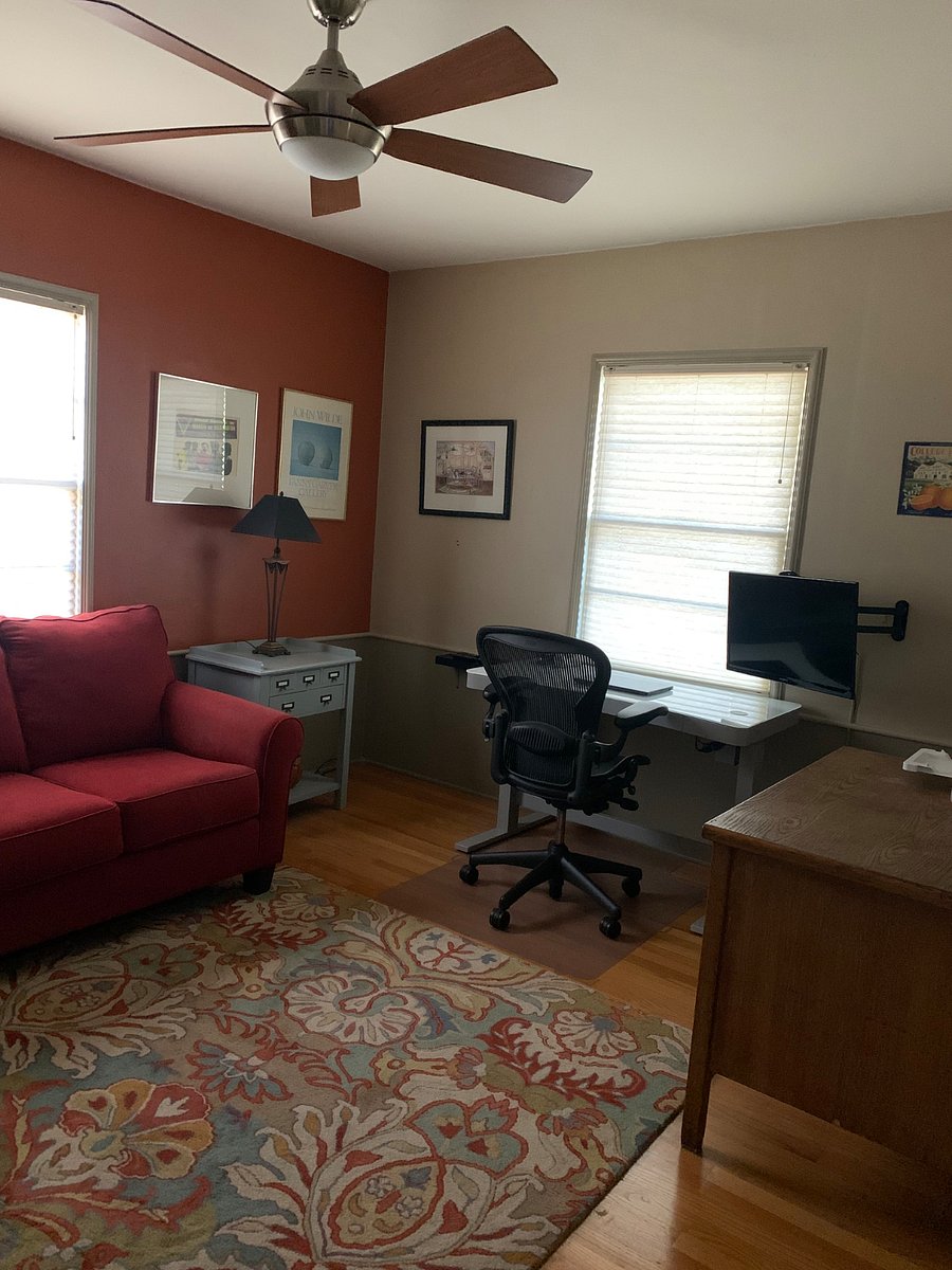 Study, has a sit stand desk, red couch pulls out to be a sleeper.