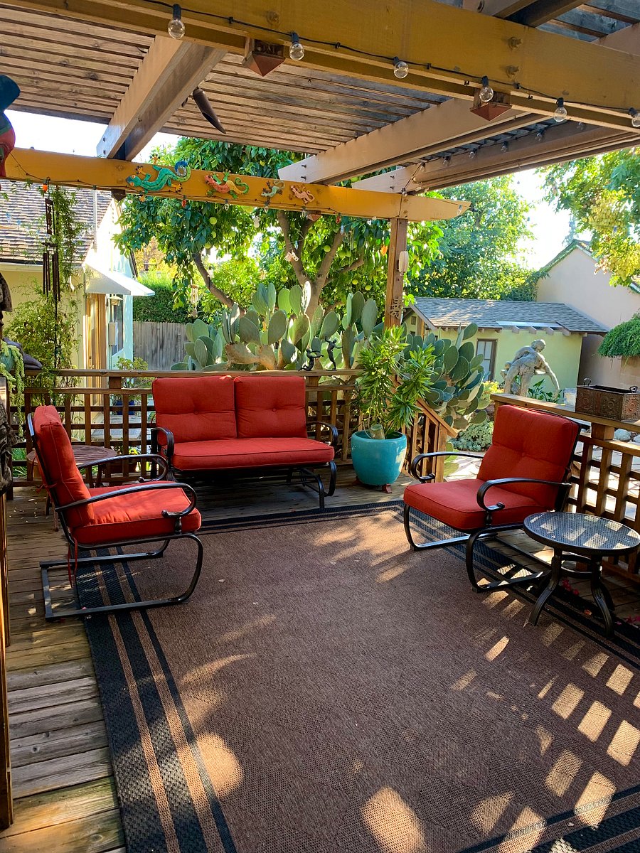 Lovely deck in backyard with fountain.