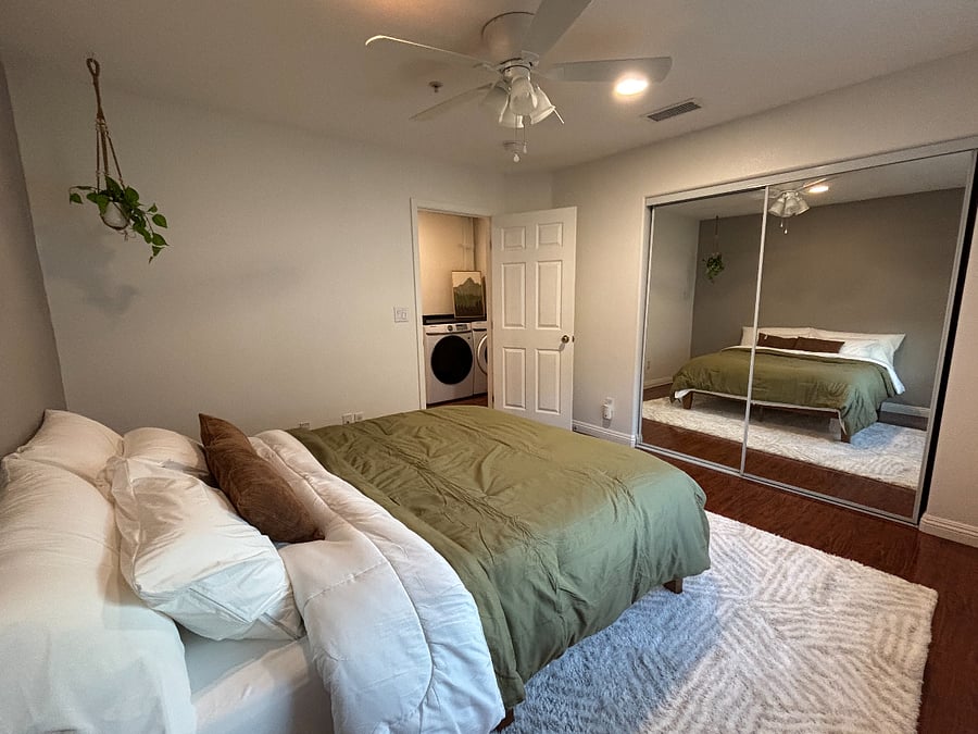 Second bedroom with a large, dual-mirror sliding door closet 
