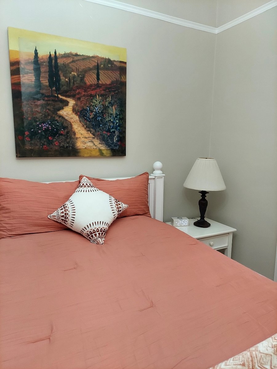 Nightstand with clock radio, USB and phone wireless charging enabled. New bedding and mattress.