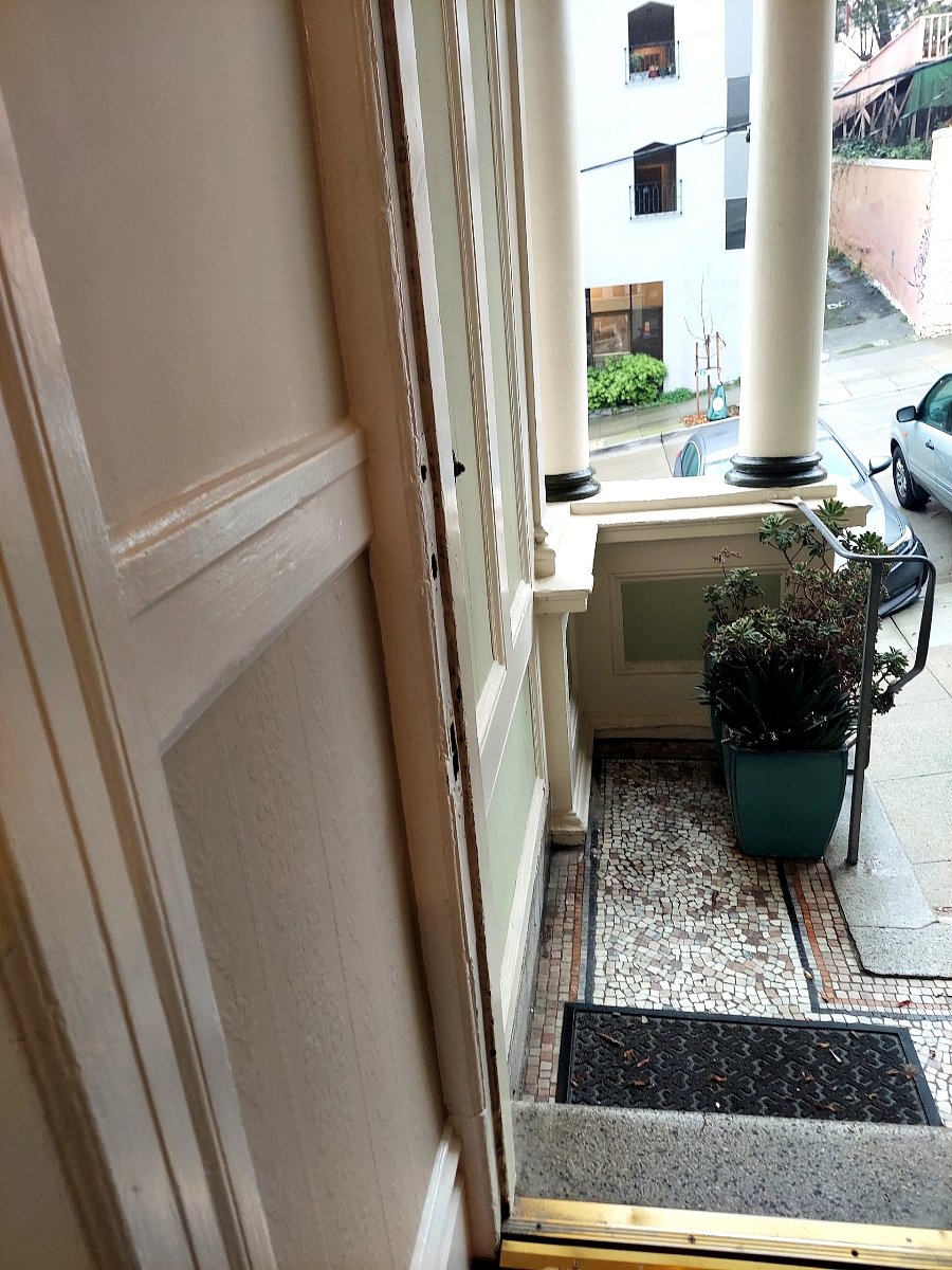 Original mosaic tiled front entry.