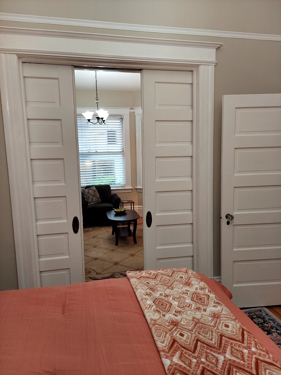 Bedroom and living room connect through pocket doors.