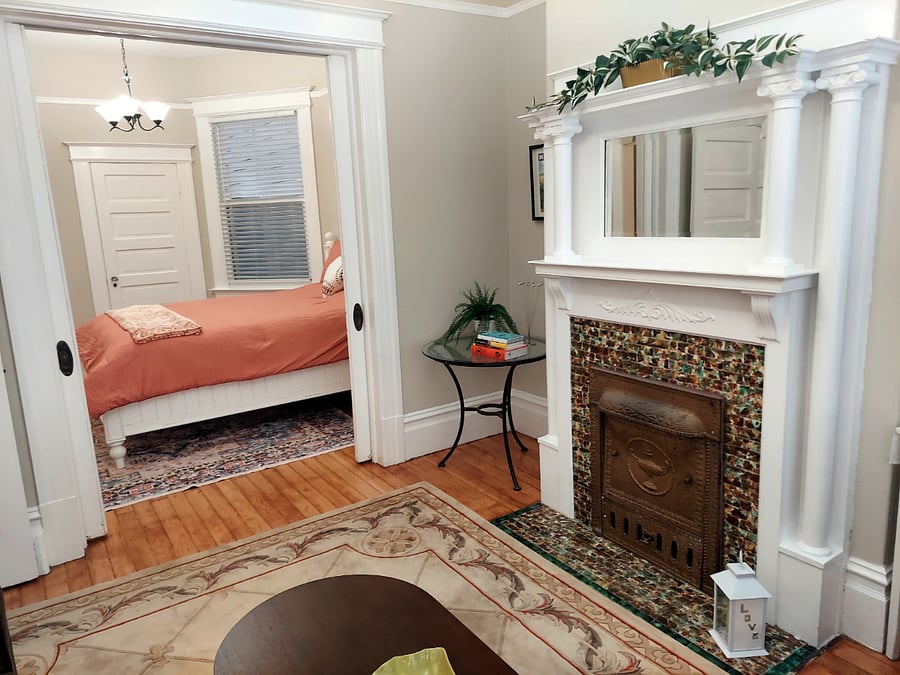 Original 1907 tiled hearth front.
Pocket doors separate the living and bed rooms