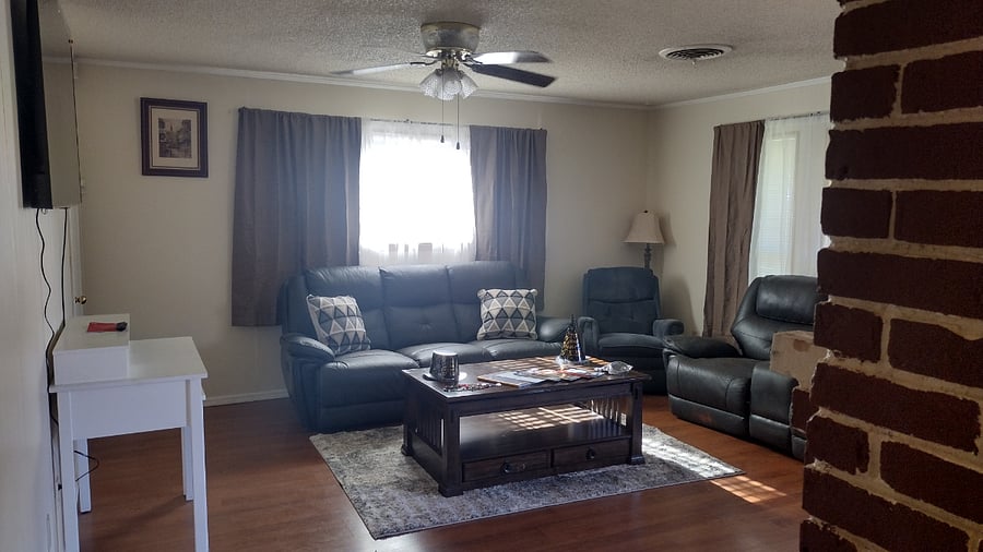 A large living room, with a 65 inch screen to watch your favorite movies . Reclining couches, Large coffee tables.and end tables with charging ports for your phones.