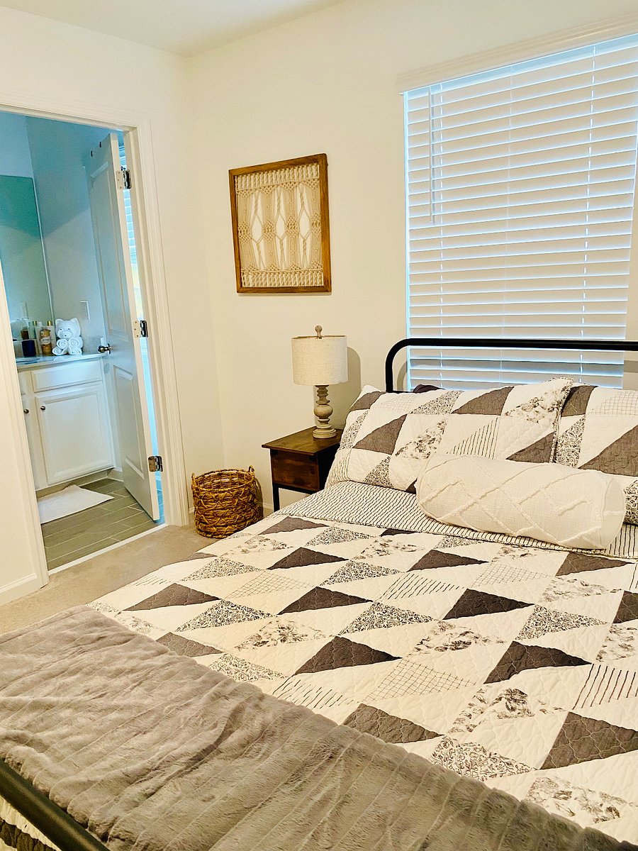 Relax in the second bedroom, featuring an ensuite bathroom, a full-size bed for restful sleep, a Roku TV for entertainment, and a large closet for your belongings.