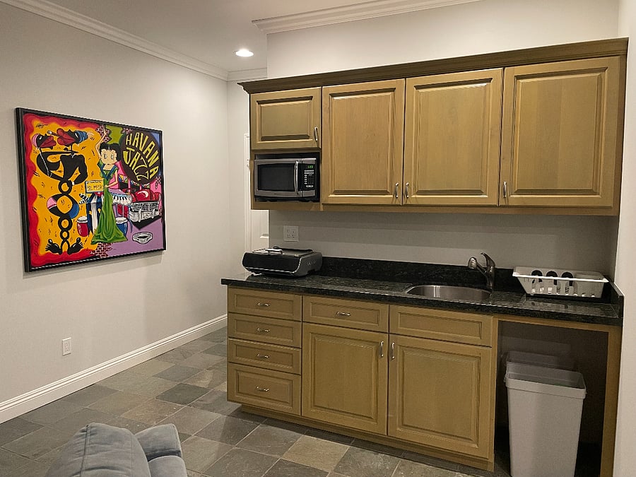 Kitchen area with microwave and airfryer. Cupboards and drawers include all dishes, silverware, cookware, and utensils.