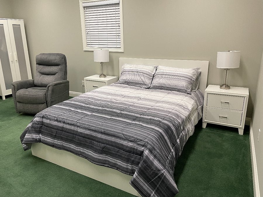 Bedroom #1 - Queen bed, recliner chair, TV with fire stick, wardrobe and dresser.