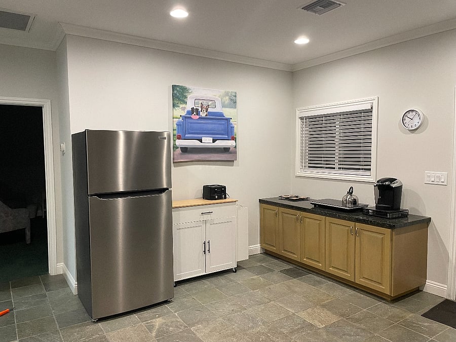 Kitchen area with full size refrigerator, Keurig coffee maker, toaster, 2-burner induction cooktop, and Instapot. Kitchen