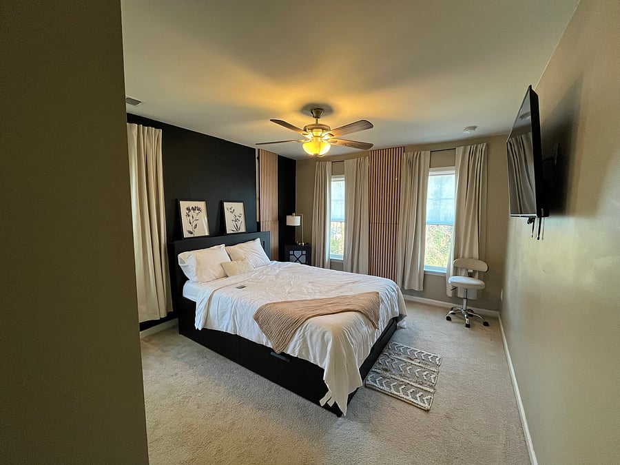 Bedroom 2 includes queen, 4 drawer storage bed, black out curtains, large smart tv and wide closet