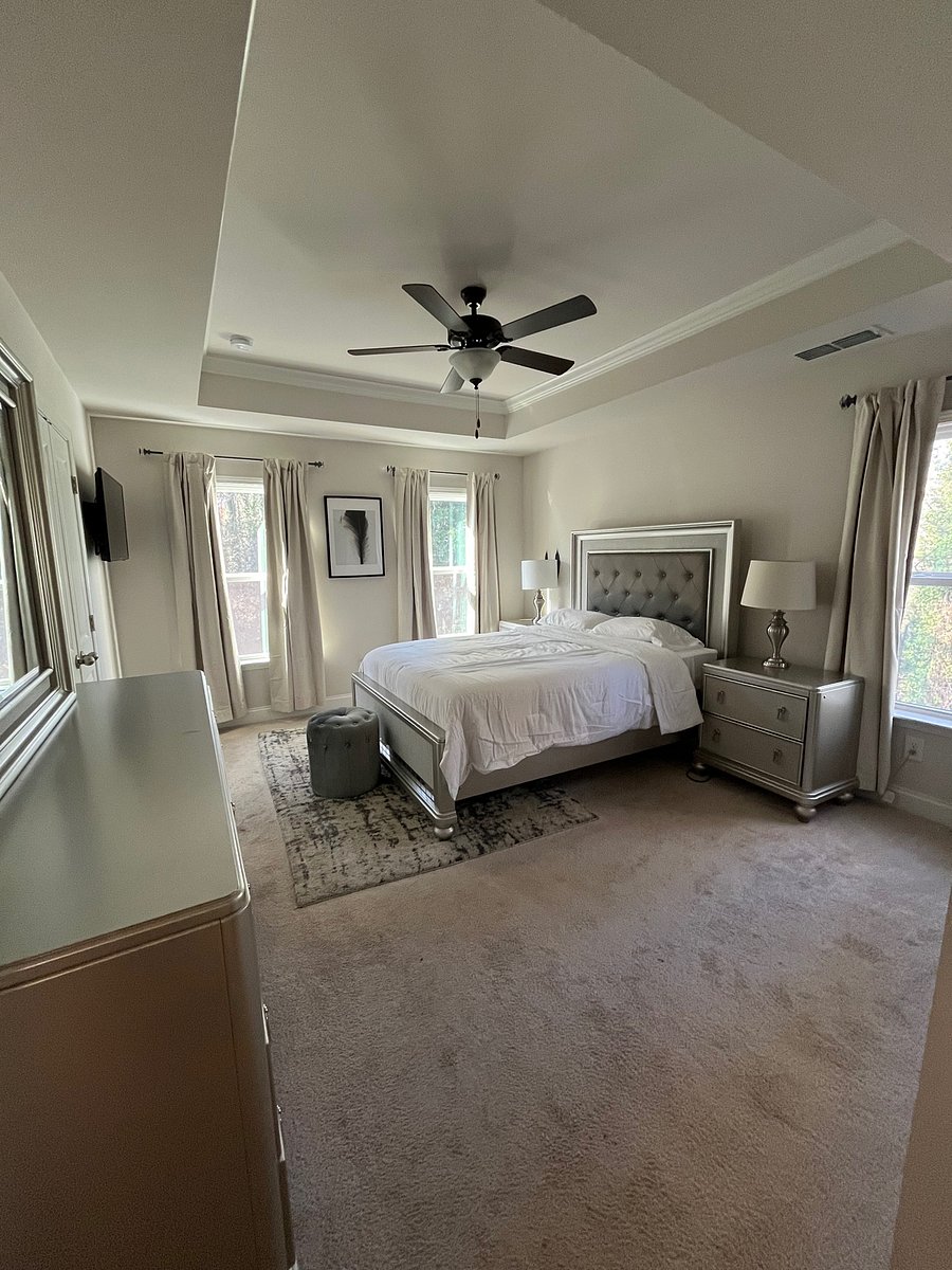 Primary Suite includes smart TV, Blackout curtains, dresser and walk in closet.