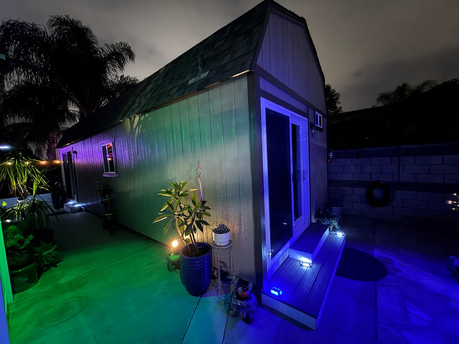 Back side of La Casita including side view of la Casita with solar lighting at night, area is well lit-up.