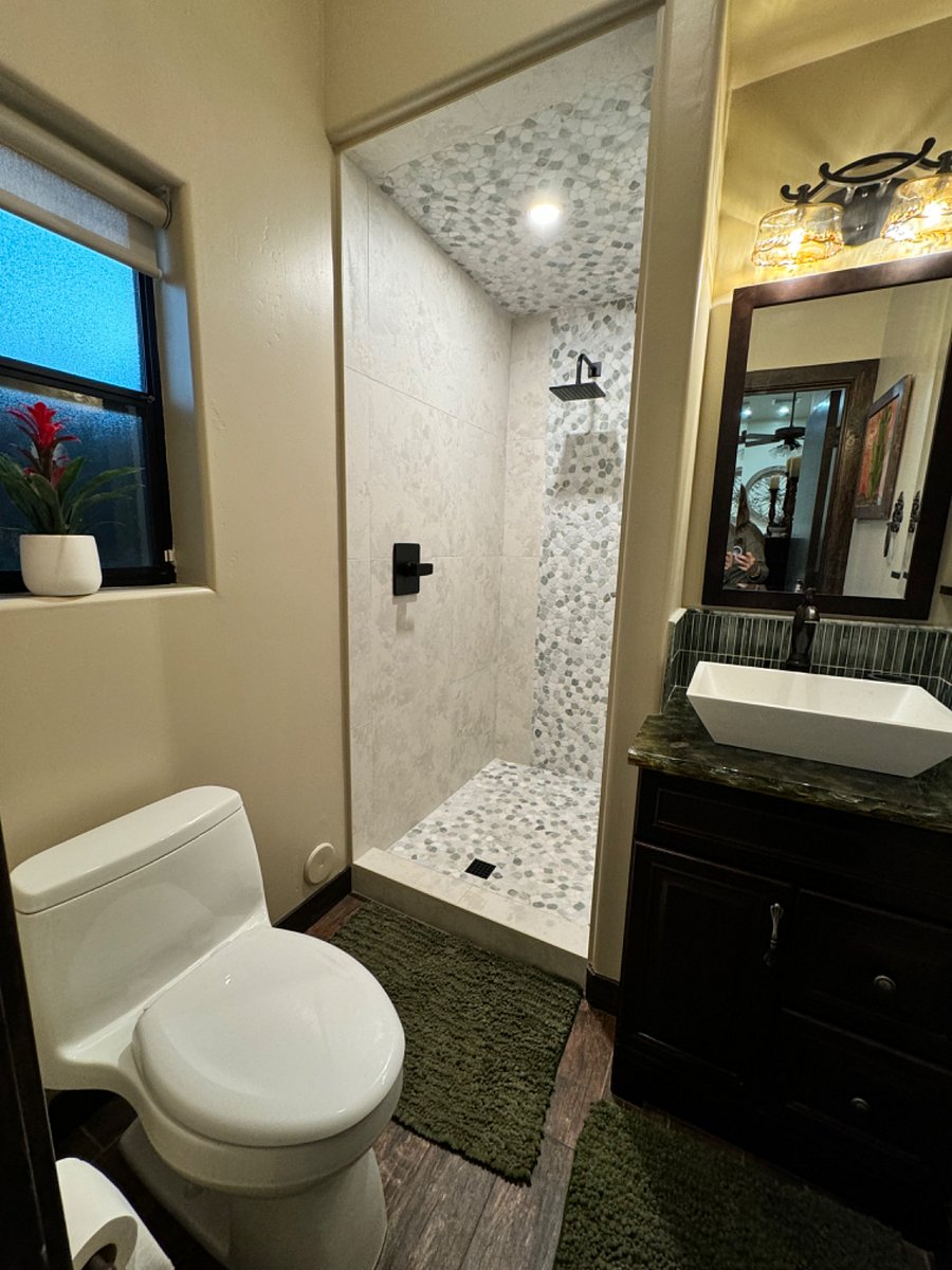 Shower area includes glass door, rain held and a hand held with a 6 hose all natural shower. 