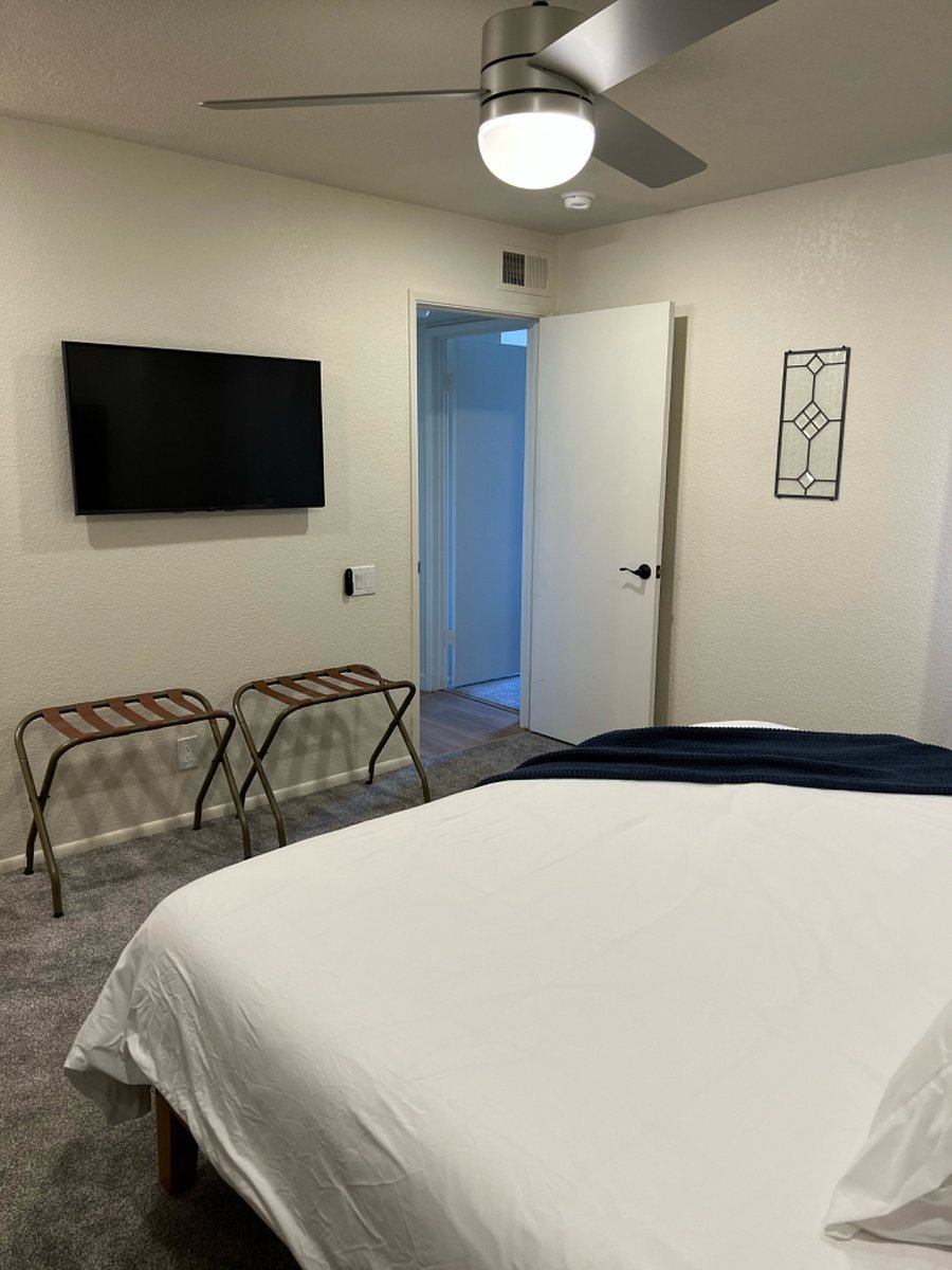 Main bedroom has a ceiling fan, smart TV, wardrobe mirror and two luggage racks. There is a full bathroom in the main bedroom equipped with iron and blow dryer.