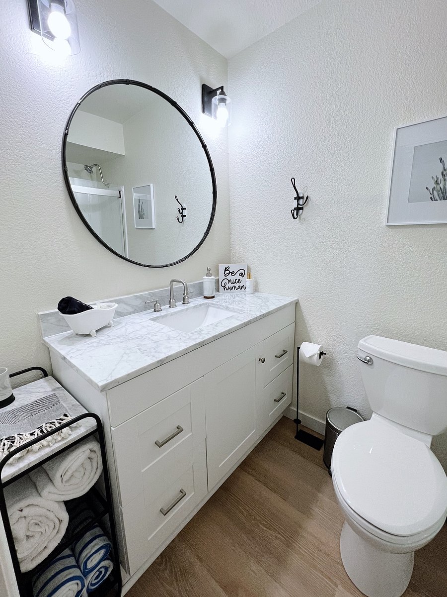 Beatiful vanity with quartz counters, bath and pool towels, upgraded lighting, new flooring, and new glass shower doors. We provide travel-size toiletries that include shampoo, conditioner, body wash, and lotion.