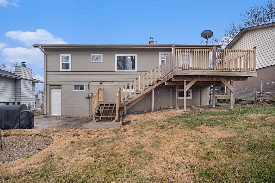 Large fenced in backyard with deck and patio, as well as firepit.