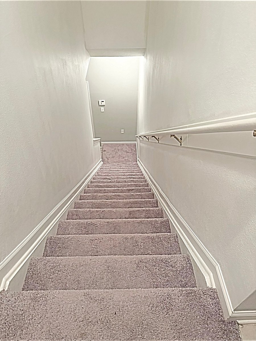 Stairs leads to attached one car garage 