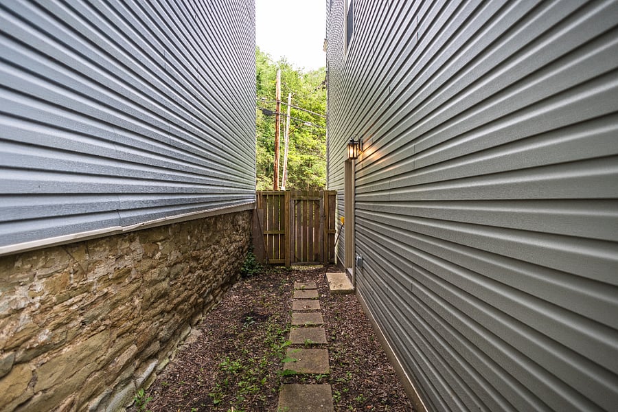 Private and fully fenced passage way to backyard.