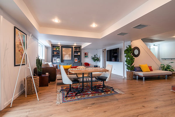 New luxury vinyl plank brightens the open concept living area, while local art and vintage textiles warm up the space.