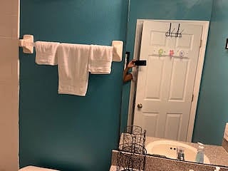 Guest bathroom, door with hooks