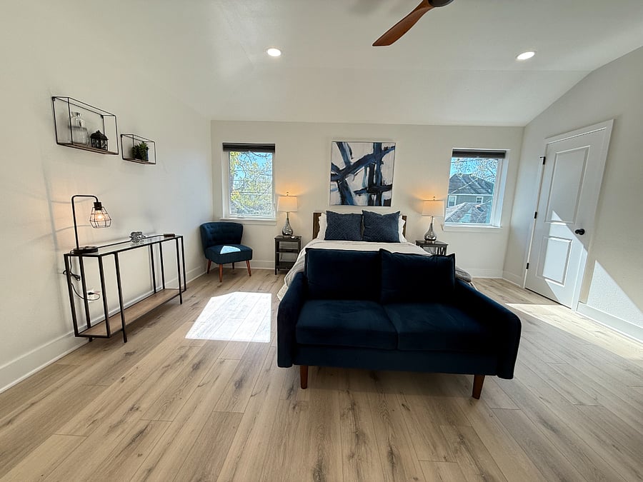 Rest and recharge in the spacious Indigo Room, featuring a queen-size bed, TV, and basic exercise equipment.
