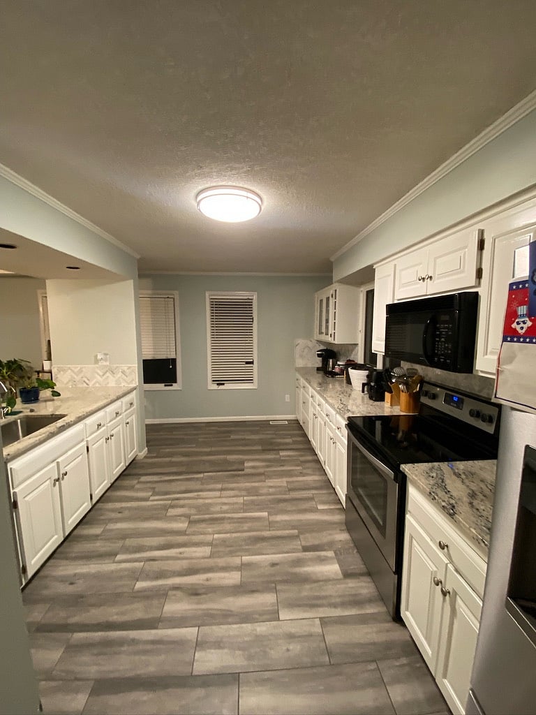 Kitchen with full size appliances, pots, pans, dishware, and spices