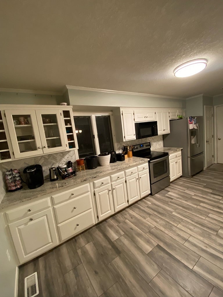 Kitchen with full size appliances, pots, pans, dishware, and spices