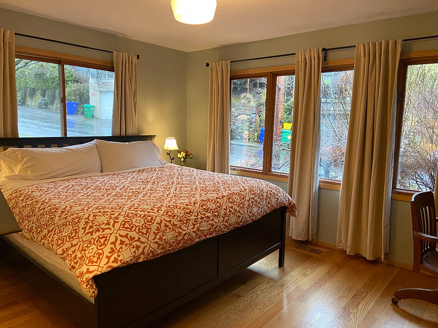 King bedroom with a Tempurpedic memory foam mattress, Herman Miller desk chair, desk, smart TV, black out curtains and large closet.