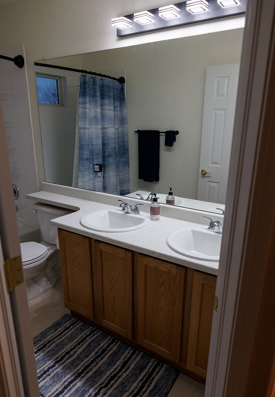 Private bathroom updated sinks and vanity light