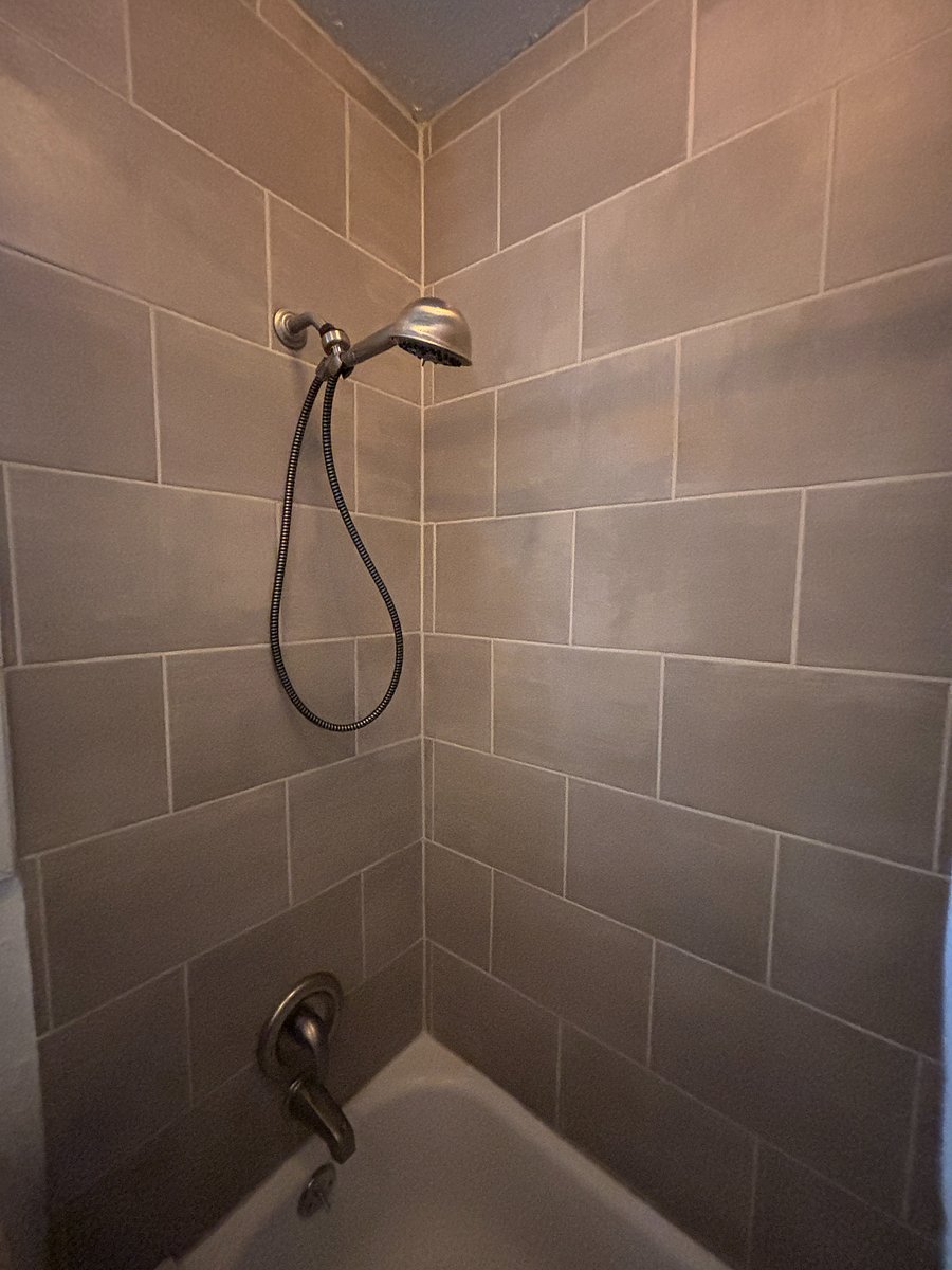tiled shower and tub, hand held shower head