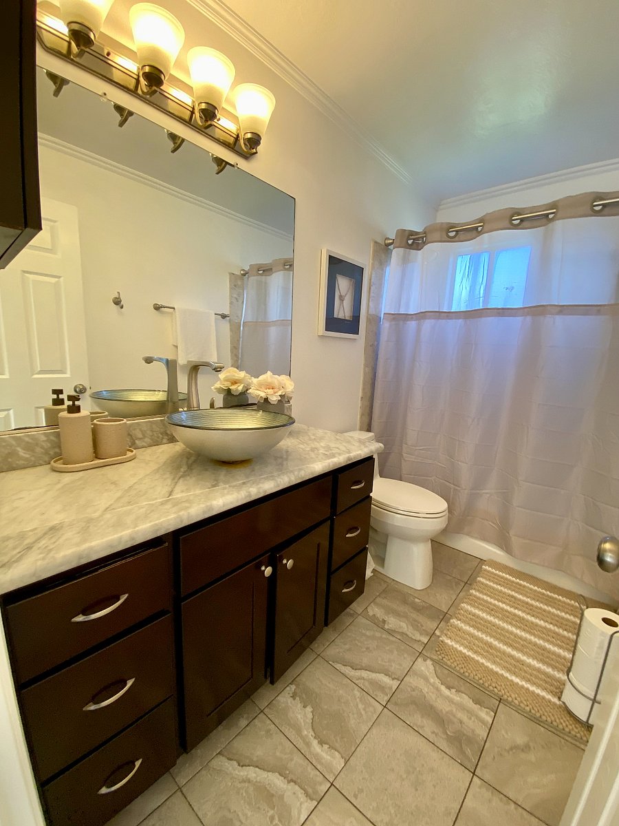 Shared bathroom at the end of hallway. Tub / shower