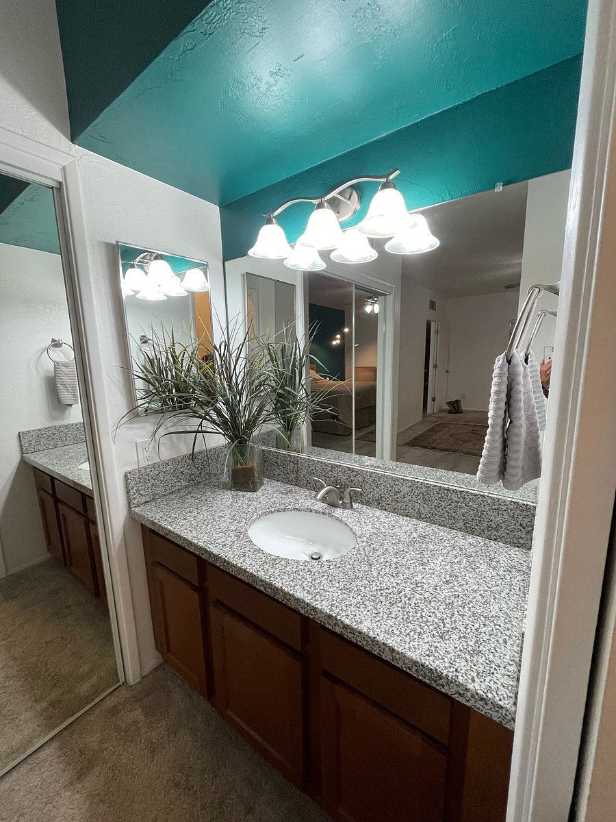 Master bath features separate dressing/ sink area with granite countertops. Soap, shampoo, conditioner, and hand soap provided. 
