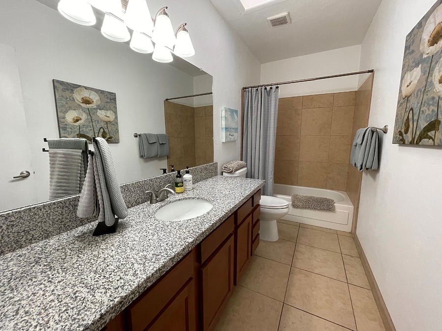 Second bath with tub and shower located in hallway.  Plenty of room in drawers and cabinets for personal items and supplies.   All bath linens provided. Starter supply of hand soap, shampoo, conditioner, and body soap provided.   