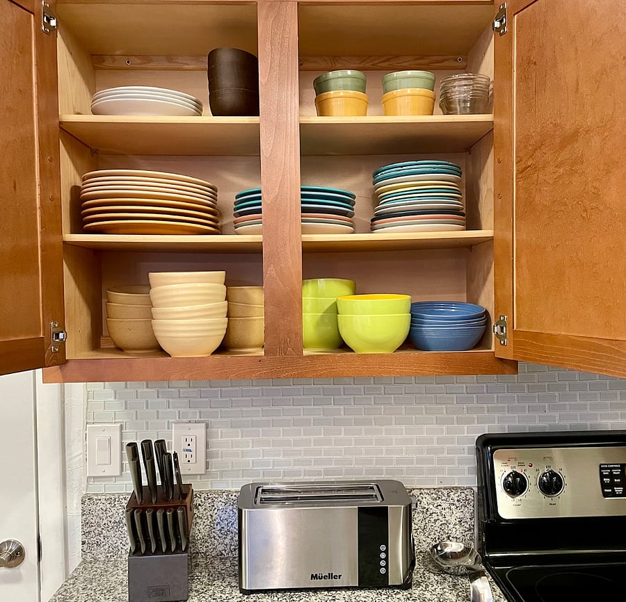 A variety of dinnerware and serving pieces includes Fiesta Ware 