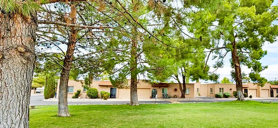 Large grassy area with tall trees by pool area.  Neighborhood borders Rolling Hills Golf Course.  