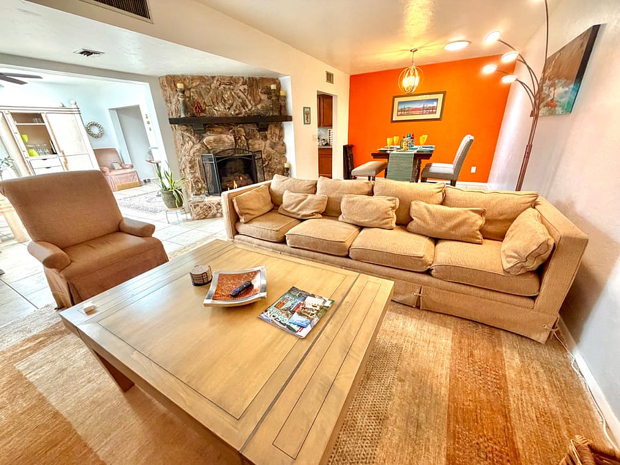 Living room with fireplace adjoins breakfast dining area.  