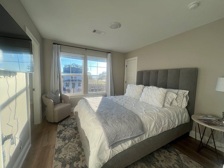 Queen bed, ocean view from chair in bedroom