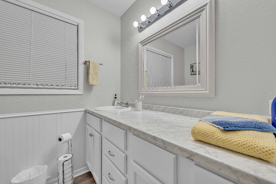 bathroom 2 with large garden tub with toiletries