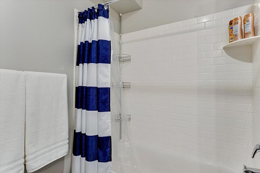 Tub & Shower with soap, conditioner/shampoo dispensers.