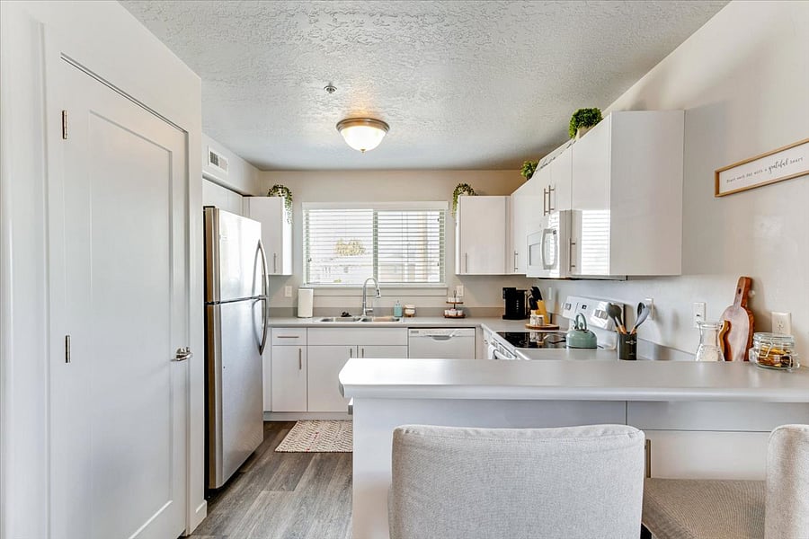 Light filled kitchen that is fully equipped will make cooking enjoyable.