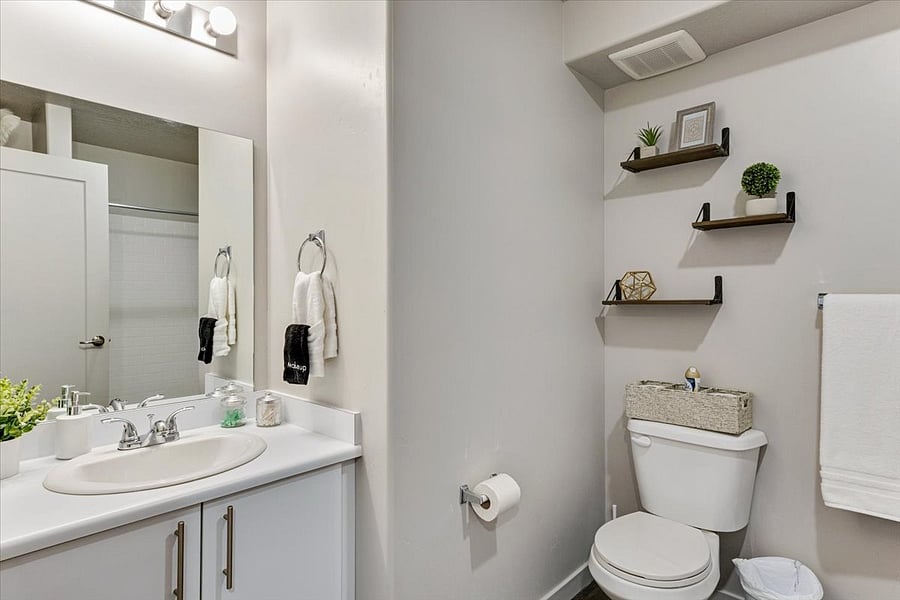 The bathroom is equipped with a hair dryer, towels, and starting toiletries.