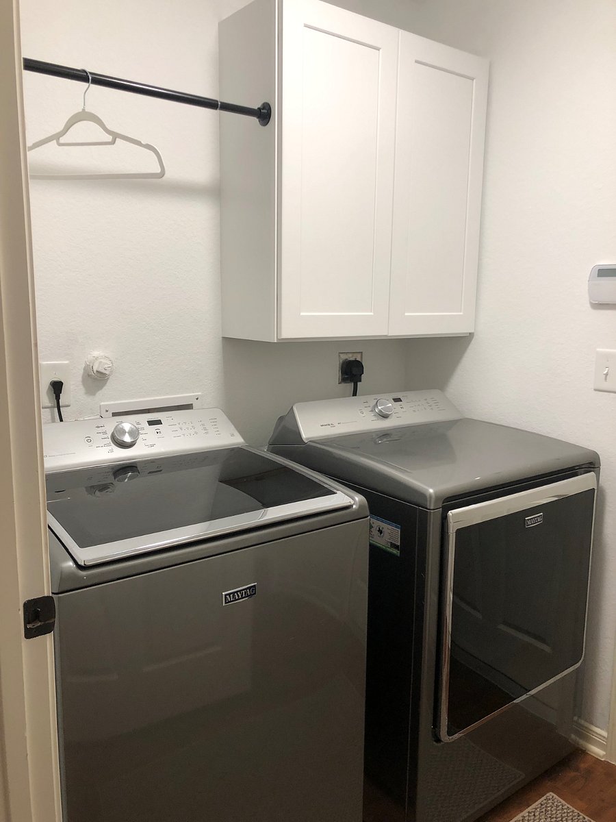 Washer and dryer included in separate laundry room.