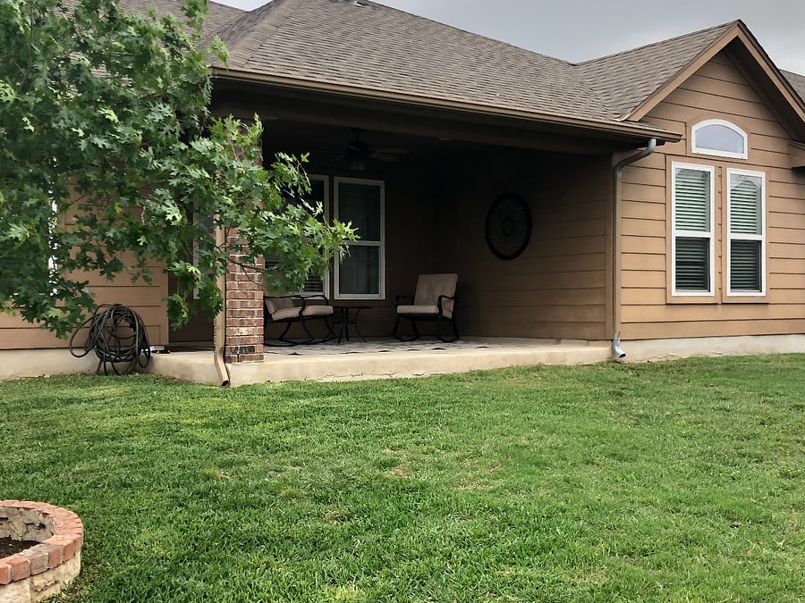 Backyard is fenced and includes storage shed.