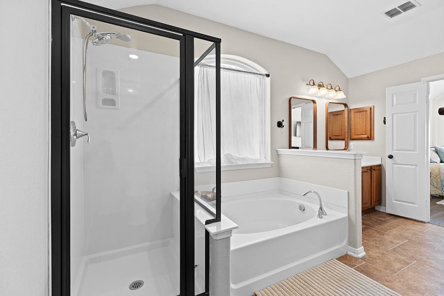 Large master bathroom has shower, soaking tub, and walk in closet with custom shelving.